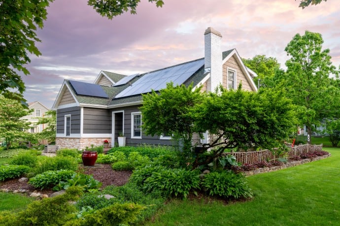 Beautiful restored home with solar panels on roof and large garden